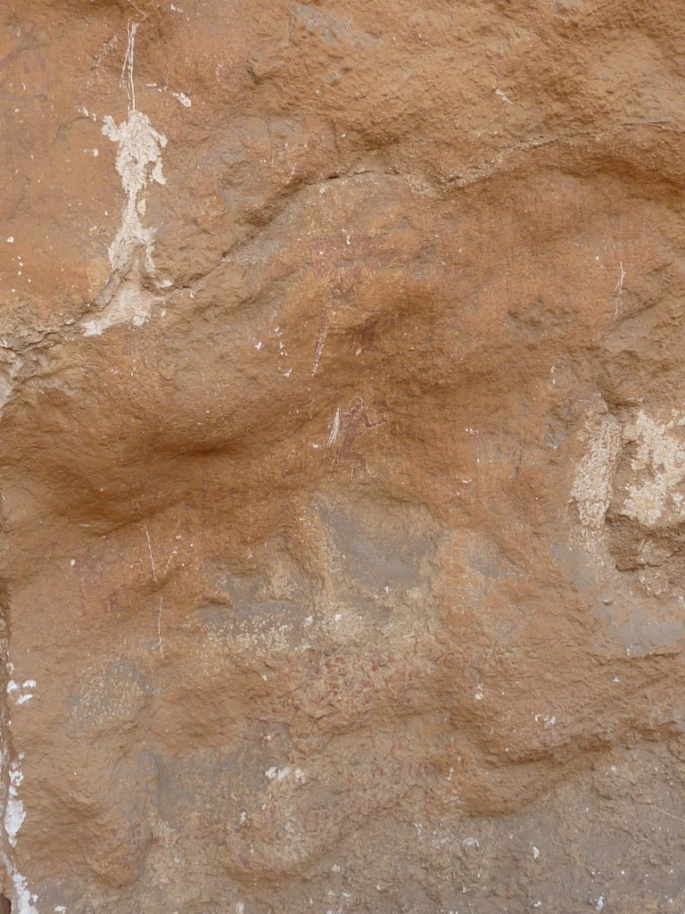 A quarried face with traces of red paint from multiple First Intermediate Period graffitos.