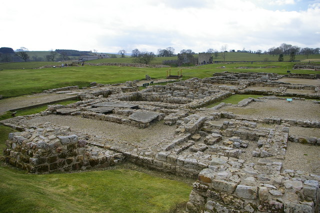 View of the Roman fort at Vindolanda showing conserved walls, surrounded by gravel.