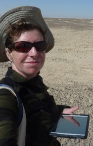 Photo of the author during the survey, with tablet in hand and the Hatnub desert in the background.