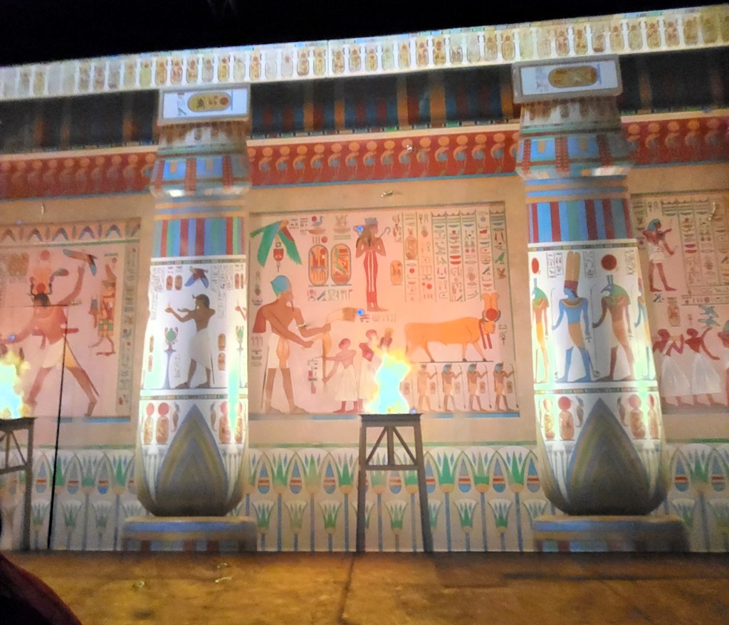 Recreation of an ancient Egyptian temple wall, fully decorated with coloured ritual scenes. 