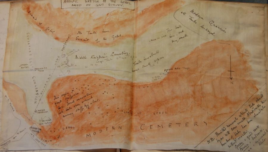 A hand-drawn map with the geology of the gebel marked in orange and tombs with their numbers marked as ink points.