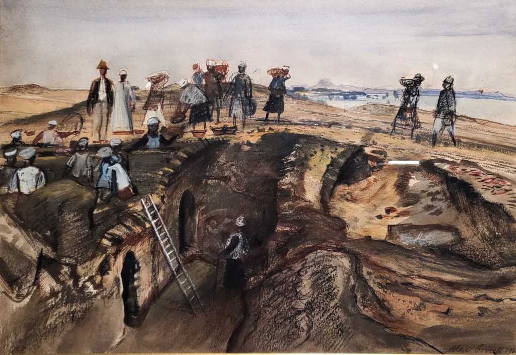 Painting of an archaeological excavation with a deep trench containing two arched doorways preserved to head-height. A ladder leads down to the doorwatys. Various individuals wearing local styles of dress are visible in the trench and carrying baskets of spoil away. A person in European dress stands watching the work, with another in a white-blue Egyptian galabiya behind him. The Nile and typically Nubian mountains lie behind.